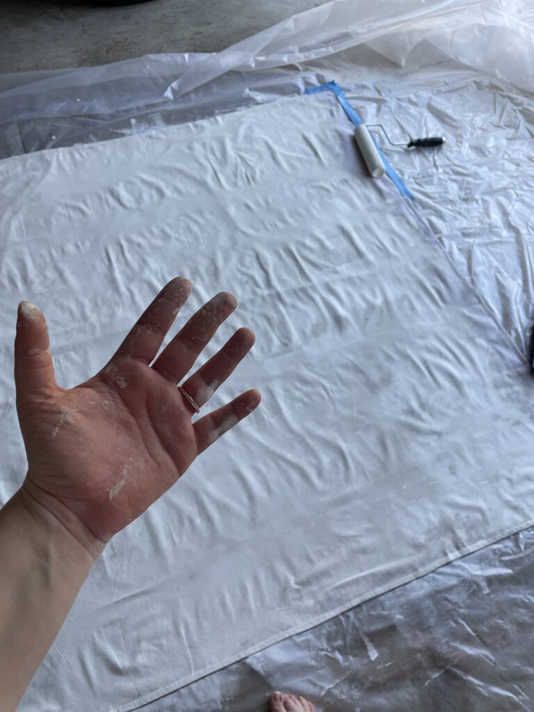 painting canvas drop cloth with paint roller